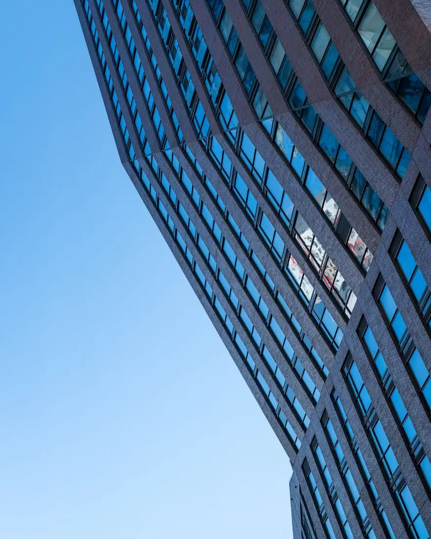 Sleek glass facade of a high-rise condo in downtown Toronto, Ontario.