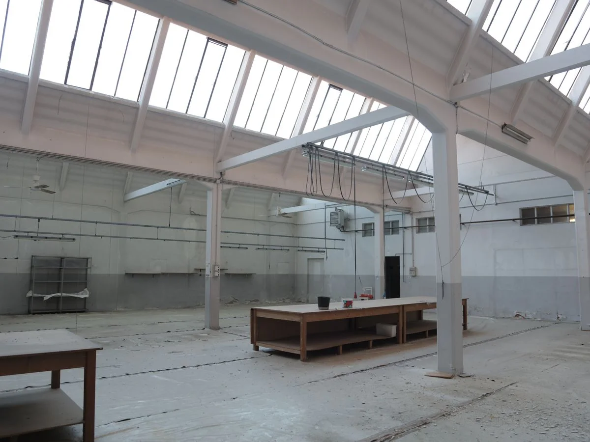 Bright premise for storage with concrete floor and metal beams inside modern industrial building