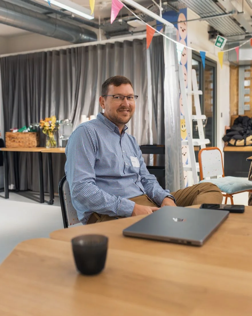 Man sitting at a desk, relaxed atmosphere in a modern office with decor.