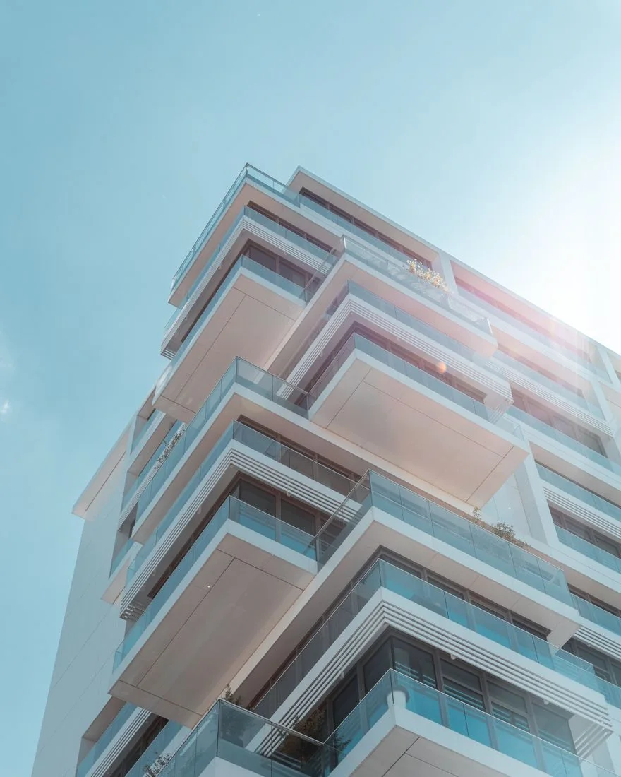 A stunning view of a modern residential building in Berlin with geometric balconies against a clear blue sky.